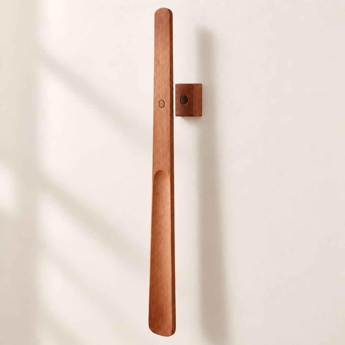 Brown wooden magnetic shoehorn with matching wall mount